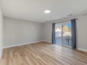 Empty room featuring light wood-type flooring and baseboards