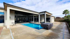 Swimming pool featuring a fire pit and a patio area