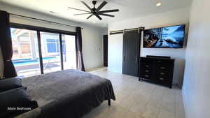 Primary Bedroom featuring a barn door, a ceiling fan, recessed lighting, access to exterior, and light tile patterned floors