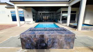 Outdoor pool with a patio and an outdoor fire pit