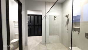 Primary Bathroom featuring a stall shower and light tile patterned floors