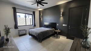 Casita bedroom with light tile patterned floors, ceiling fan, and a textured ceiling