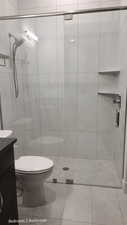 Bathroom 2 with a stall shower, vanity, and tile patterned floors