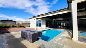 View of swimming pool with a patio area, an outdoor fire pit, and a fenced backyard
