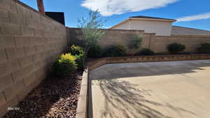 View of fenced backyard and drip irrigation planters