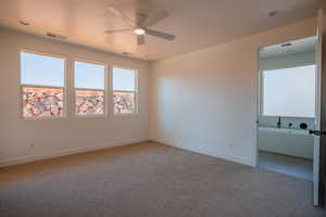 Unfurnished bedroom featuring light colored carpet and ceiling fan
