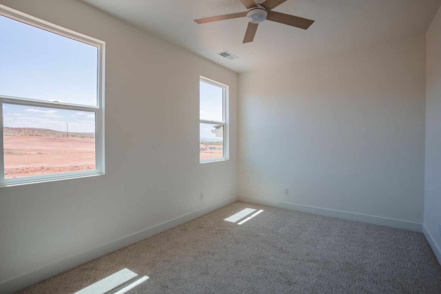 Spare room with carpet flooring and a ceiling fan