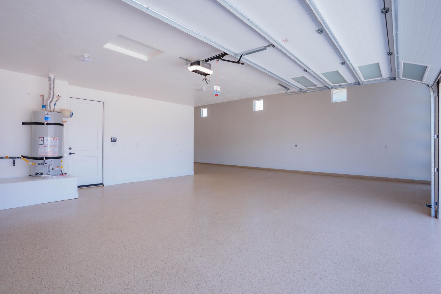 Garage featuring strapped water heater