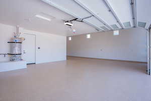 Garage featuring strapped water heater