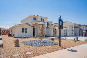 View of front of house featuring stucco siding and driveway