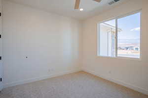 Empty room with light carpet, a ceiling fan, and recessed lighting