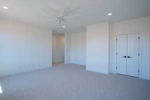 Unfurnished bedroom with light carpet, recessed lighting, ceiling fan, and a closet