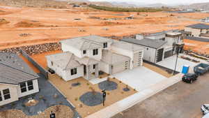 Aerial view of sparsely populated area with a mountain backdrop and nearby suburban area