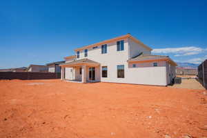 Rear view of property with a patio area, a fenced backyard, and stucco siding