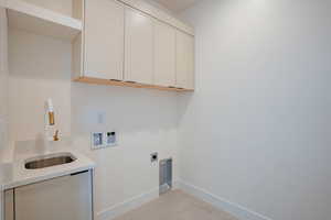 Laundry room with cabinet space, washer hookup, and hookup for an electric dryer