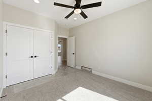Unfurnished bedroom featuring carpet flooring, a ceiling fan, a closet, and recessed lighting