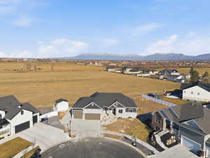 Aerial view of sparsely populated area with nearby suburban area and mountains