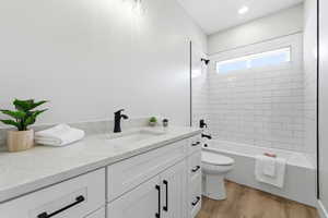 Full bathroom featuring vanity, light wood-type flooring, and bathtub / shower combination