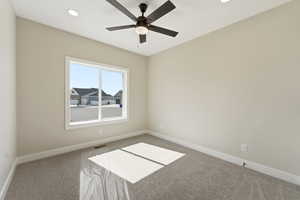 Empty room with carpet floors, ceiling fan, and recessed lighting