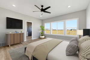 Bedroom featuring light wood-style floors, ceiling fan, ensuite bathroom, and recessed lighting