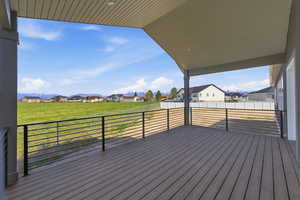 Wooden terrace featuring a residential view and a yard