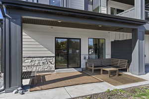 Entrance to property featuring stone siding