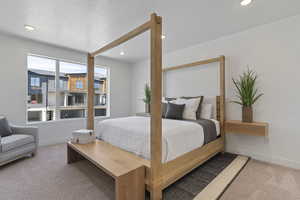 Carpeted bedroom featuring recessed lighting and a textured ceiling