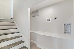 Staircase with baseboards and carpet floors