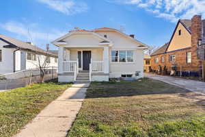 Bungalow featuring brick siding and a porch