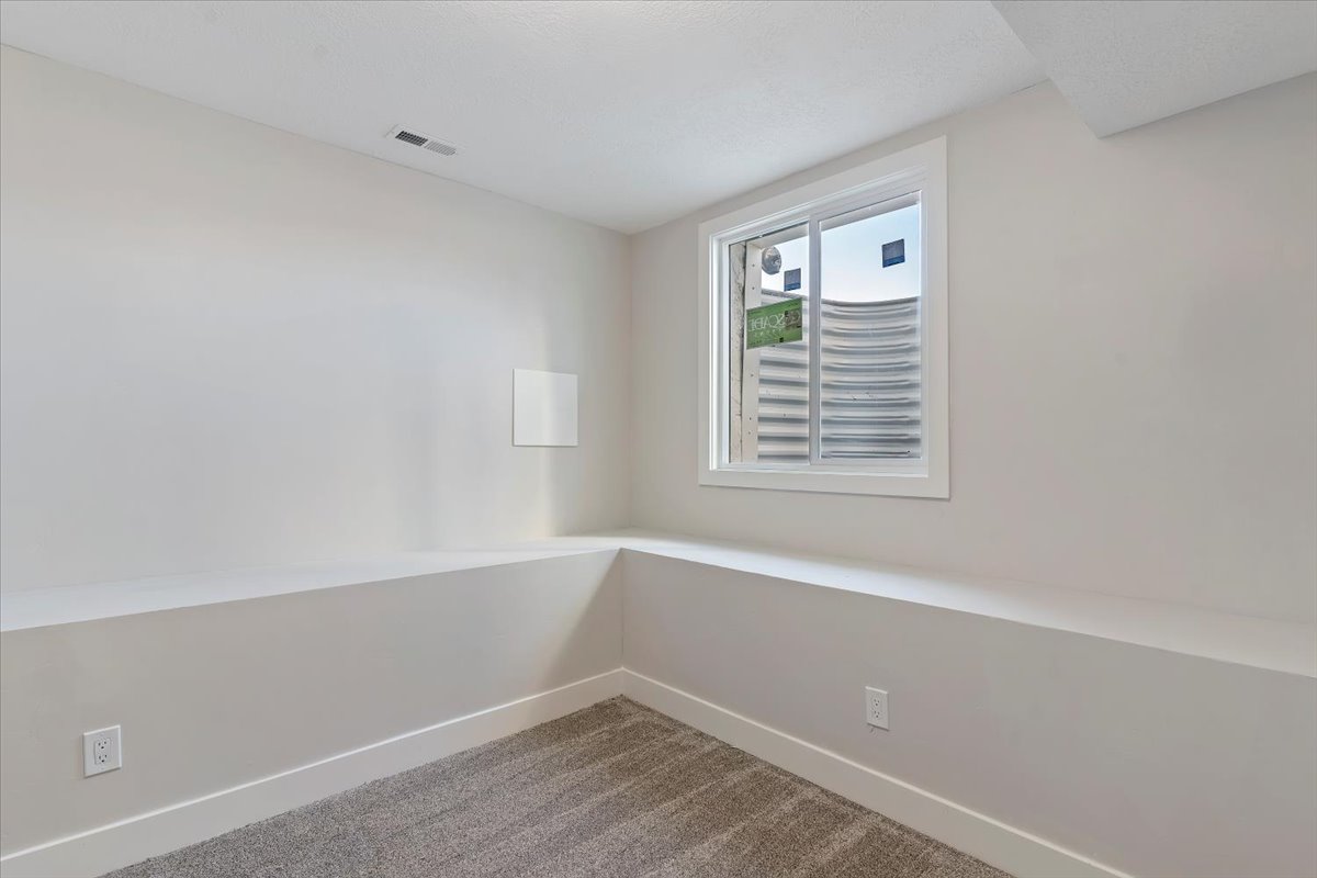 Unfurnished room featuring carpet floors and baseboards