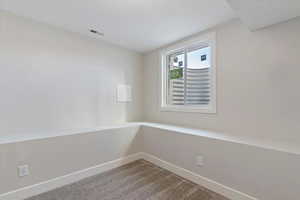 Unfurnished room featuring carpet floors and baseboards