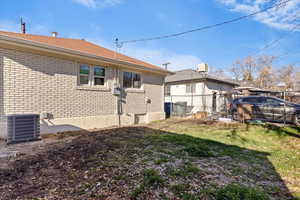 View of property exterior featuring brick siding and a cooling unit