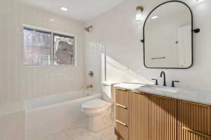 Full bath with vanity, shower / bath combination, recessed lighting, and light marble finish flooring