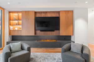 Living room with recessed lighting and light wood-style floors