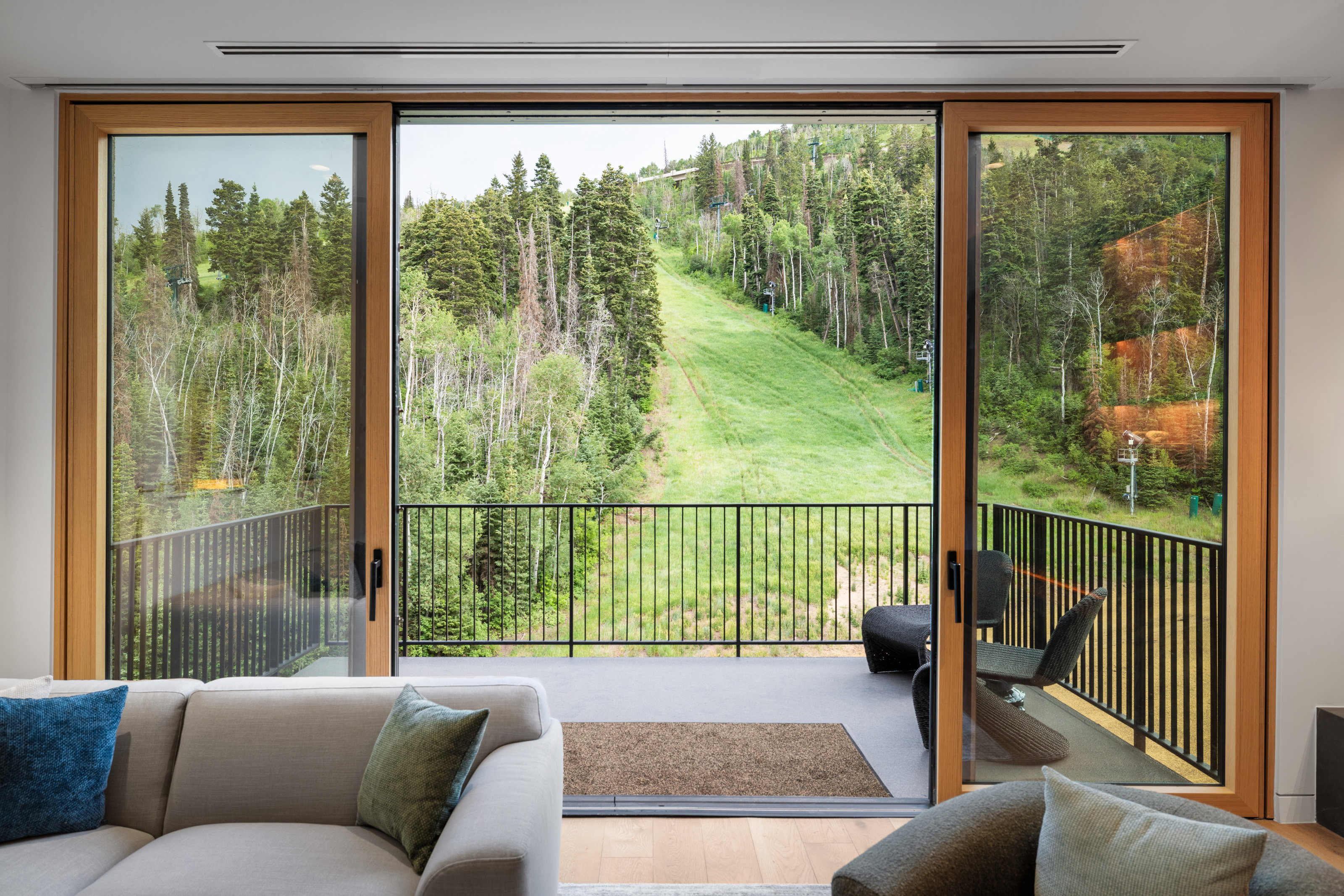 Entryway featuring wood finished floors, view of wooded area, and plenty of natural light