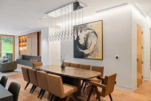 Dining space with light wood finished floors and recessed lighting