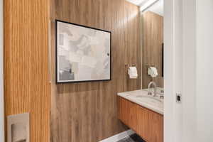 Bathroom with wooden walls and vanity