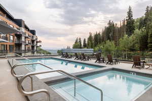 Community pool featuring a patio and a hot tub