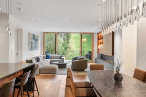 Dining space featuring a wall of windows, light wood-type flooring, and recessed lighting