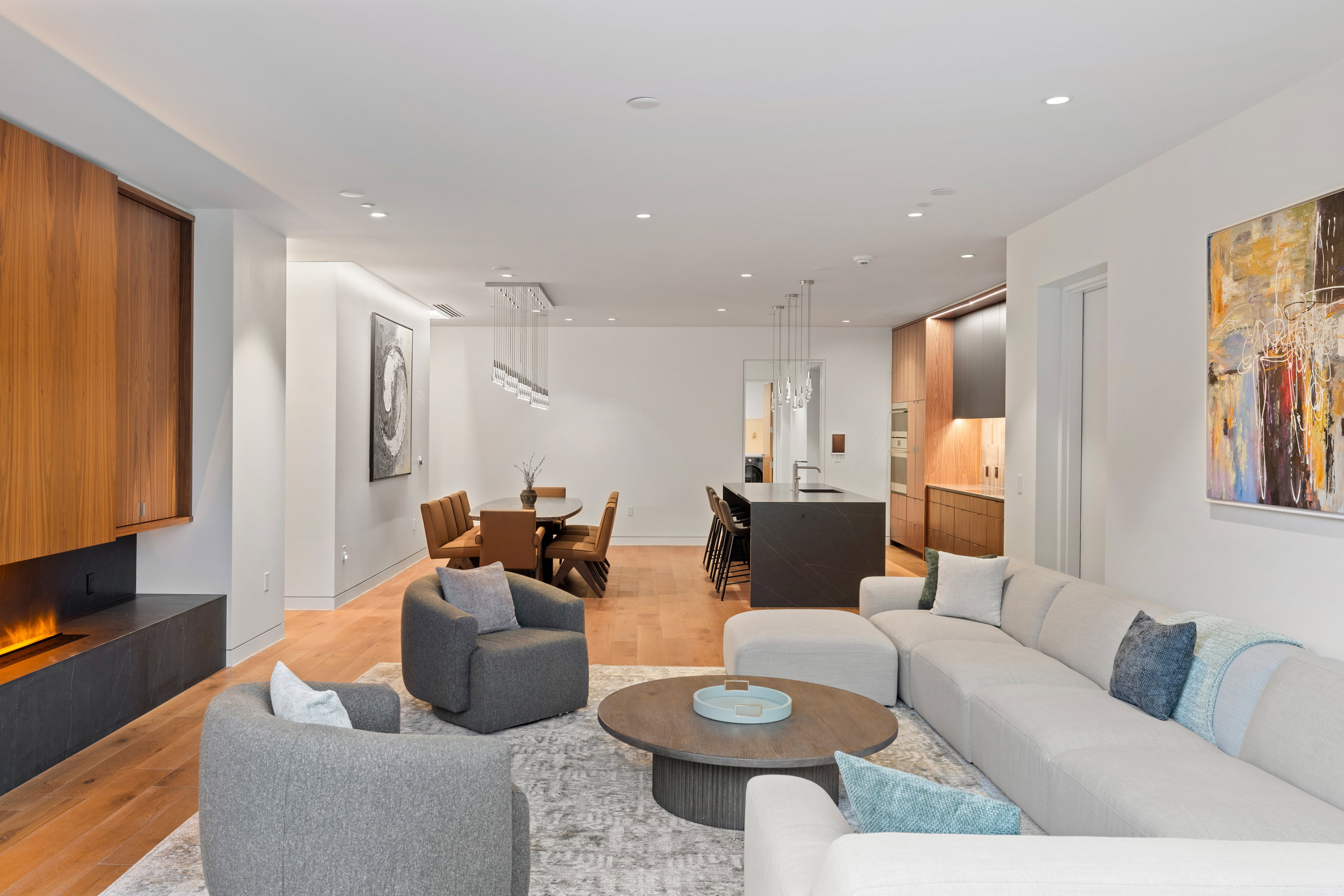 Living room with light wood-type flooring and recessed lighting