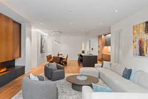 Living room with light wood-type flooring and recessed lighting
