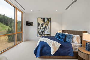 Bedroom featuring expansive windows, carpet floors, and recessed lighting