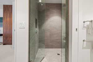 Bathroom featuring walk in shower and light colored carpet