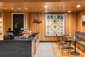 Bar with dark countertops, wood ceiling, recessed lighting, and wooden walls