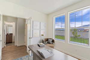Home office featuring a water view and light wood finished floors