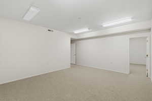 Carpeted spare room with baseboards
