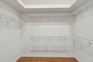Walk in closet featuring wood finished floors