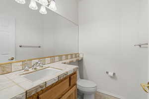 Bathroom featuring vanity and baseboards