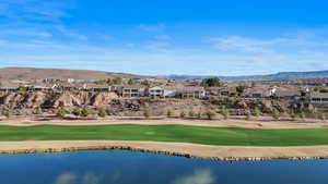 Aerial perspective of suburban area with a water and mountain view and a local golf course