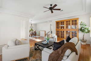 Living area featuring hardwood / wood-style flooring, ceiling fan, and a chandelier